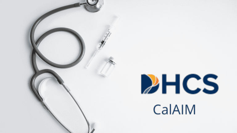 Stethoscope and syringe laid out on a white background