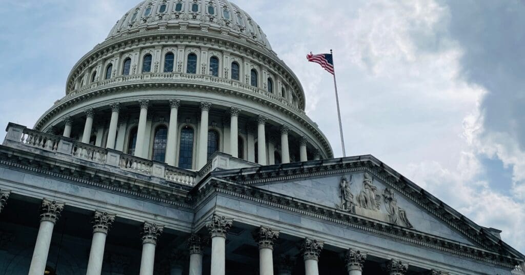 low angle shot of the US Capitol and cloudy sky
